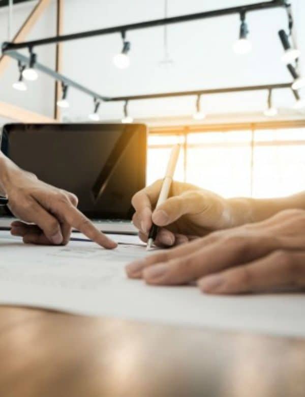 Two architects engineer discussing data working tablet laptop with blueprint closeup hands project print 1423 556 600x780